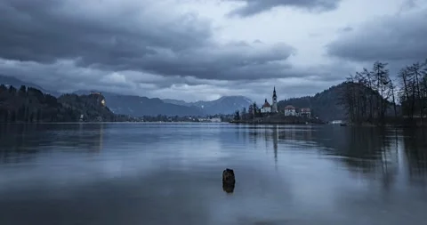 Time lapse of clouds moving over lake Bled and Alps mountains Stock Footage 148123099