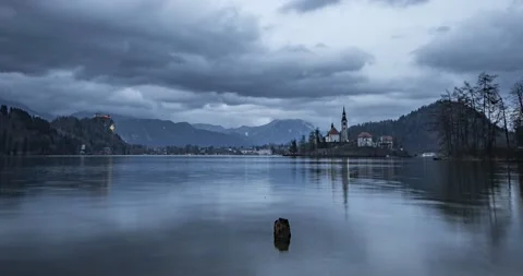 Time lapse of clouds moving over lake Bled and Alps mountains Stock Footage 148123206