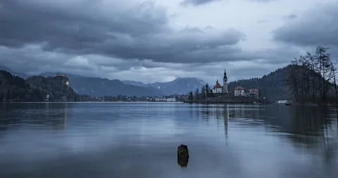 Time lapse of clouds moving over lake Bled and Alps mountains Stock Footage 148123210
