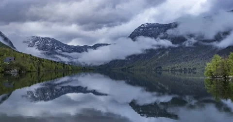 Time lapse of clouds moving over Alps mountains and Alpine lake Bohinj Stock Footage 153992497