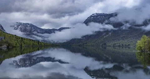 Time lapse of clouds moving over Alps mountains and Alpine lake Bohinj Stock Footage 153992620