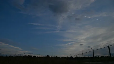 Time lapse of clouds moving over farming field in the evening Stock Footage 163374441