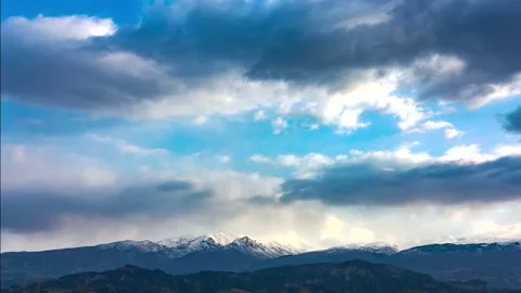 Time Lapse of Clouds Moving Over the Snowy Tops Video stock 180448714