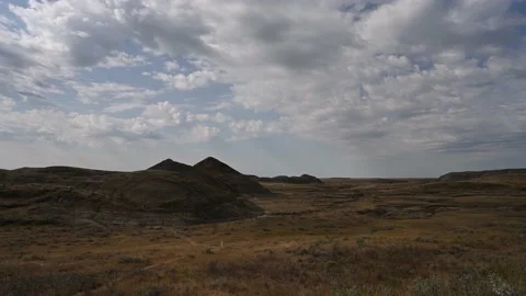 Time lapse of clouds moving over a badlands desert setting in fall brown colors. Stock Footage 209721989