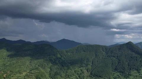Time lapse clouds moving over mountains, drone view of rolling rainy clouds Stock Footage 285515083