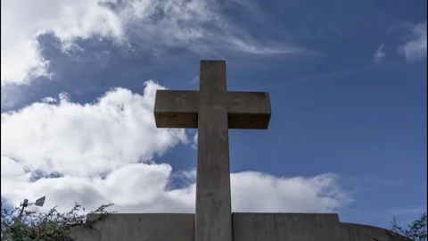 Time lapse of clouds moving over a large cross landmark Stock Footage 321354106