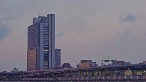 Time-lapse of Clouds Moving Over Modern Skyscrapers and Highway at Dusk Stock Footage 333416299