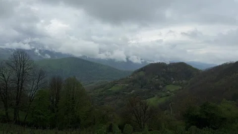 Time lapse of clouds moving over green mountains landscape Stock Footage 333708149