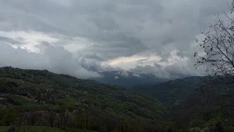 Time lapse of clouds moving over green mountains landscape Stock Footage 333708239