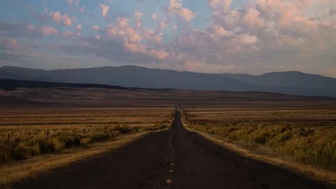 Time lapse of clouds moving over a straight empty highway in Utah country Stock Footage 344451762
