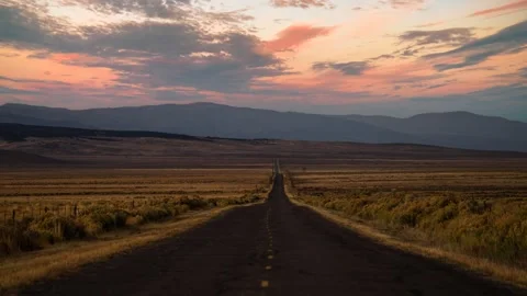 Time lapse of clouds moving over a straight empty highway in Utah country Stock Footage 344451910