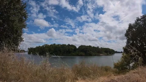 Time lapse of clouds moving over a scenic bend of the Sacramento River Stock Footage 346272127