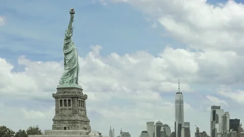 Time lapse of clouds moving past statue of liberty with manhattan skyline. Stock Footage 130339165