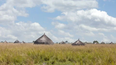 Time lapse of clouds moving past huts in Africa Stock Footage 139415026