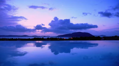 Time lapse of clouds moving quickly over reflective water Stock Footage 56467221