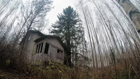 Time-lapse of clouds moving in the sky behind forsaken house Stock Footage 158112679