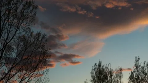 Time-lapse of clouds moving through sky at dusk into night Stock Footage 73051132
