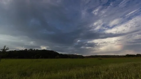 Time lapse of clouds moving toward camera over green grass Camera moves sideways Stock Footage 152905636