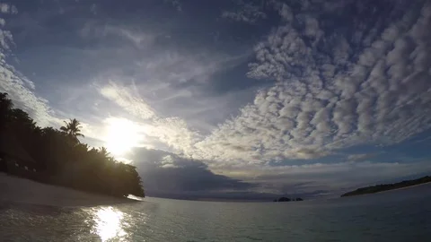 Time lapse of clouds moving in on a tropical island 動画素材 127618403