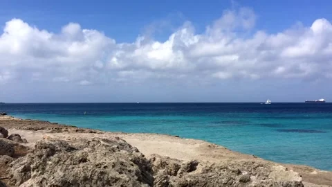 Time-lapse of clouds moving on tropical island beach, white rock and blue sea. Stock Footage 242094163