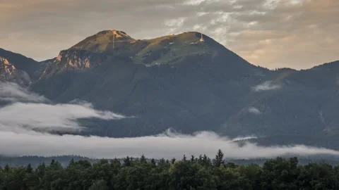 Time lapse of clouds moving under the mountain in the valley Stock Footage 133900076