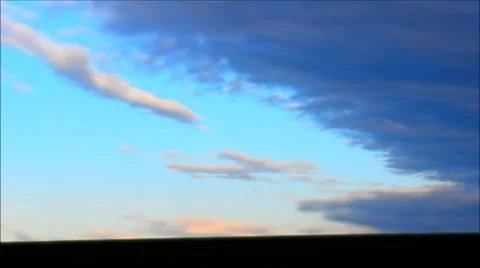 Time lapse of clouds moving in windy sunrise - tilt shift effect. Stock Footage 44983395