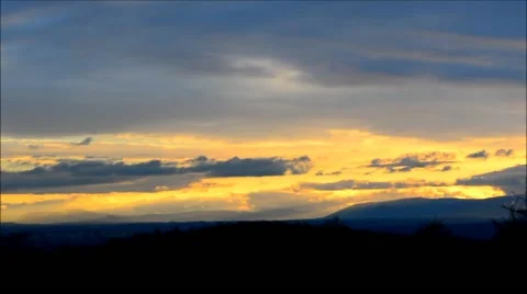 Time lapse of clouds moving in windy sunrise - tilt shift effect. Stock Footage 44983396