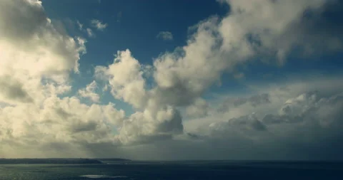 Time Lapse - Clouds obscuring sky and shadowing the sea - warm film tones. Stock Footage 150593074