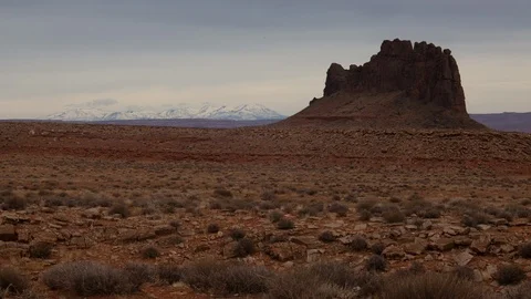 Time lapse of clouds over Alhambra Rock and a snow covered Abajo Mountain range Stock Footage 123238562