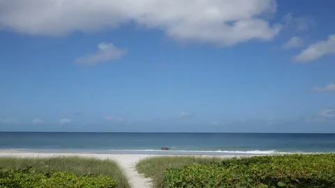 Time Lapse of Clouds Over Beach Path Stock Footage 77054262