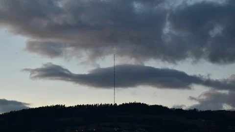 Time lapse - clouds over broadcasting tower on the top of the hill. Day to night Stock Footage 104546221