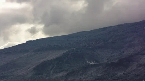 Time lapse clouds over dark mountain Stock Footage 83081280