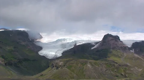 Time lapse clouds over glacier descending down mountains Stock Footage 37779187