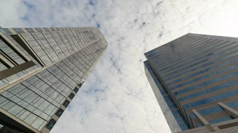 Time Lapse of clouds over glass tower buildings with glass reflection 4k Stock Footage 59966363