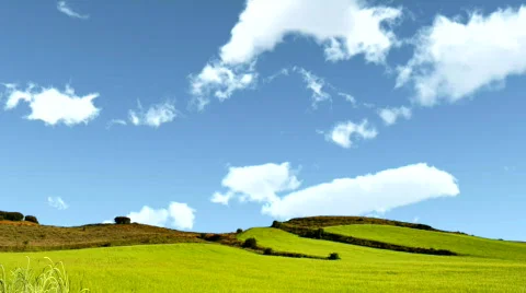 Time lapse of clouds over green hills Stock Footage 557023
