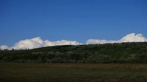 Time lapse of clouds over a green hill Stock Footage 38949605