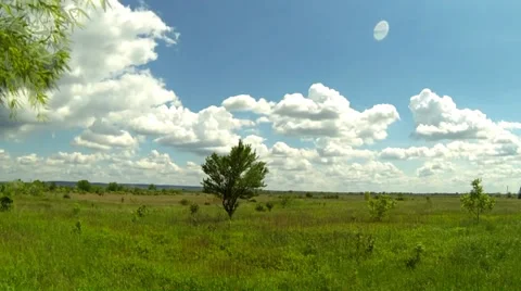 Time lapse of clouds over a green field Stock Footage 38950310