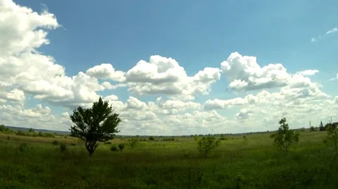 Time lapse of clouds over  green field Stock Footage 38950710