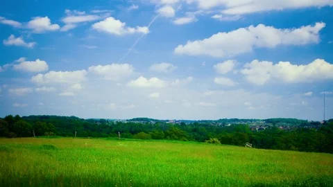 Time lapse of clouds over green field Stock Footage 79284385