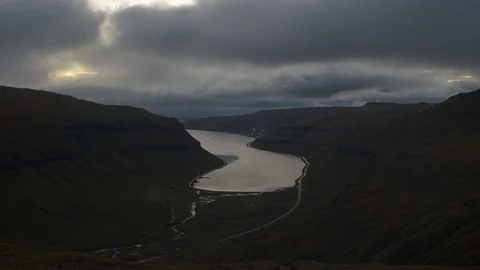 Time-lapse of clouds over the green mountain and river at dusk Stock Footage 116599717