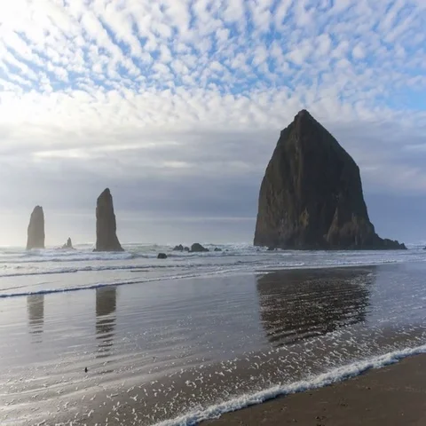 Time lapse of clouds over Haystack Rock at low tide in Cannon Beach OR 4k uhd Stock Footage 69491036