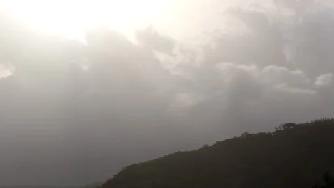 Time lapse of clouds over a hill. 스톡 동영상 87732208