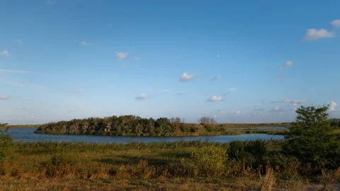 Time lapse of clouds over lake island Stock Footage 115890910