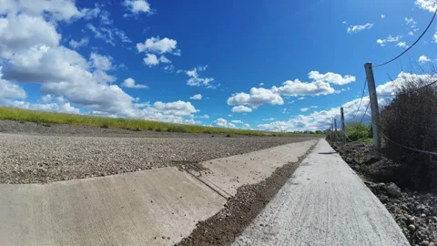 Time lapse of clouds over a levee Stock Footage 284982139