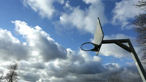 Time lapse of clouds over a metal basketball hoop Stock Footage 33894522