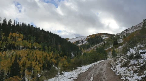Time lapse-Clouds over mountain Dark green pines Golden aspens Stock Footage 67894839