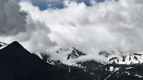 Time lapse clouds over mountain peaks covered with snow Stock Footage 162615464