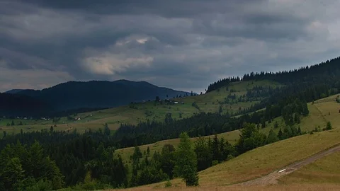 Time lapse of clouds over mountains road Stock Footage 70924664