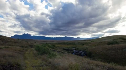 Time lapse of clouds over mountains and stream at Highmoor in Maloti Drakensberg Stock Footage 155387191