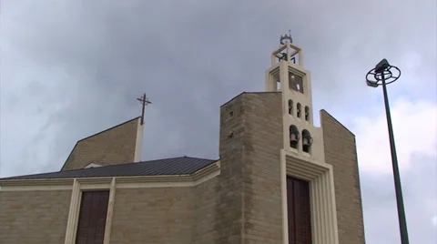 Time lapse on clouds over newish catholic church Stock Footage 37557003